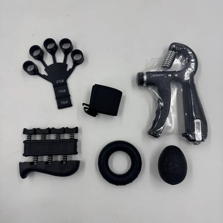 Grip strength trainer kit flat lay with adjustable hand gripper 5 to 60 kg, finger stretcher marked 13 17 21 lb, spring finger exerciser, grip ring, egg ball and carry strap